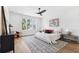 Relaxing main bedroom with plush bed, modern ceiling fan, and natural light from large windows at 4625 W El Prado Blvd, Tampa, FL 33629