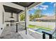 Outdoor kitchen features stainless steel appliances, granite counters, dark ceiling and overlooks a rectangular pool at 4625 W El Prado Blvd, Tampa, FL 33629