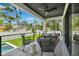 Patio features black patio furniture and overlooks a small rectangular pool and fenced yard at 4625 W El Prado Blvd, Tampa, FL 33629