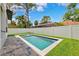 Backyard featuring a rectangular pool, grass, pavers, and a tall white fence at 4625 W El Prado Blvd, Tampa, FL 33629