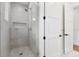 Modern bathroom featuring a glass shower with tiled walls, recessed shelf, and updated fixtures at 4625 W El Prado Blvd, Tampa, FL 33629