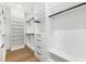 Bright walk-in closet boasts custom white shelving, drawers, and wood flooring at 4625 W El Prado Blvd, Tampa, FL 33629