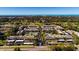 Aerial view of community with pool, tennis courts, and ocean views at 12300 Vonn Rd # 7101, Largo, FL 33774