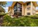 Building exterior showcasing a patio and lush landscaping at 12300 Vonn Rd # 7101, Largo, FL 33774