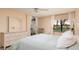 Bright bedroom with a queen-size bed, dresser, and window at 12300 Vonn Rd # 7101, Largo, FL 33774