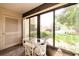 Bright screened porch with small table and chairs, overlooking the lawn at 12300 Vonn Rd # 7101, Largo, FL 33774