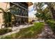Private patio with seating area, lush landscaping, and partial building view at 12300 Vonn Rd # 7101, Largo, FL 33774