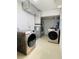 Basement laundry room with modern washer and dryer at 11452 81St Pl, Seminole, FL 33772