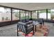 Relaxing screened porch with patio furniture and brick flooring at 11452 81St Pl, Seminole, FL 33772