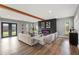 Modern living room with hardwood floors, exposed beam, and fireplace at 1715 N Alexander Rd, Tampa, FL 33603