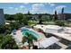 An aerial view showcases the community pool, patio area with lounge chairs and a pergola at 4460 Ironwood Cir # 405A, Bradenton, FL 34209