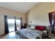 Main bedroom with a king bed and sliding glass doors to a patio at 11109 Sumner Rd, Wimauma, FL 33598