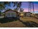 Single story house with carport and fenced yard at dusk at 11109 Sumner Rd, Wimauma, FL 33598