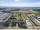 Aerial view showcasing a large lot with surrounding residential areas and agricultural land at 11109 Sumner Rd, Wimauma, FL 33598