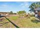 Open backyard area with some overgrown weeds and brush at 11109 Sumner Rd, Wimauma, FL 33598