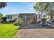 Single wide manufactured home with covered porch at 11109 Sumner Rd, Wimauma, FL 33598