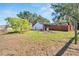 Large backyard with a partially fenced area and some overgrown weeds at 11109 Sumner Rd, Wimauma, FL 33598