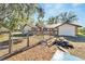 Backyard with a partially fenced area and a wood pile at 11109 Sumner Rd, Wimauma, FL 33598