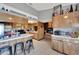 Open kitchen with wood cabinets and views to living room at 11109 Sumner Rd, Wimauma, FL 33598