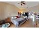Main bedroom with a king-size bed, large TV, and walk-in closet at 11109 Sumner Rd, Wimauma, FL 33598