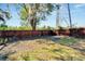 Backyard with a wooden fence, grass, and a small kiddie pool at 11109 Sumner Rd, Wimauma, FL 33598