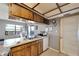 Kitchen with wood cabinets, double sink, and white appliances at 11109 Sumner Rd, Wimauma, FL 33598