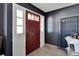 Front entry with red door and gray walls at 11109 Sumner Rd, Wimauma, FL 33598