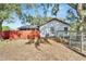 Back of house with wooden fence and garden at 11109 Sumner Rd, Wimauma, FL 33598