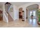 Elegant entryway with tile floors, staircase, and views into other rooms at 2727 Colewood Ln, Dover, FL 33527