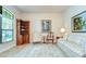 Cozy living room featuring a patterned sofa, wooden shelving unit, and lovely artwork at 2727 Colewood Ln, Dover, FL 33527