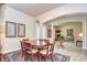 Formal dining room with a large wood table, six chairs, and an area rug at 2727 Colewood Ln, Dover, FL 33527