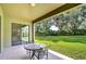 Covered patio with table and chairs overlooking the backyard at 2727 Colewood Ln, Dover, FL 33527