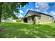 Green grassy backyard with home and trees in background at 2727 Colewood Ln, Dover, FL 33527