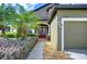 Inviting entryway with double doors and landscaping at 2727 Colewood Ln, Dover, FL 33527