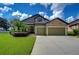 Two-story house with stone accents and two-car garage at 2727 Colewood Ln, Dover, FL 33527