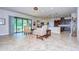Bright living room with tile floors, sliding doors to patio, and kitchen views at 2727 Colewood Ln, Dover, FL 33527