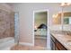 Bathroom with double vanity, tub, and access to bedroom at 2727 Colewood Ln, Dover, FL 33527
