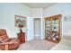 Relaxing office space with leather recliner, display cabinet, and artwork at 2727 Colewood Ln, Dover, FL 33527
