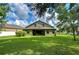 Large backyard with green grass and a home at 2727 Colewood Ln, Dover, FL 33527