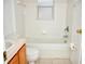 Clean bathroom with a bathtub, toilet and wood vanity at 7934 Carriage Pointe Dr, Gibsonton, FL 33534