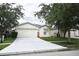 One-story house with a white garage door and landscaped lawn at 7934 Carriage Pointe Dr, Gibsonton, FL 33534