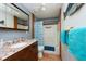 Bathroom boasts a granite vanity and a tub shower combo at 12805 Flint Creek Rd, Thonotosassa, FL 33592
