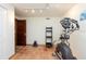 Small home gym with an elliptical and wooden shelving at 12805 Flint Creek Rd, Thonotosassa, FL 33592