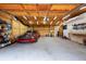 Well-lit garage featuring overhead lighting and car storage at 12805 Flint Creek Rd, Thonotosassa, FL 33592