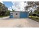 Detached garage with two blue doors at 12805 Flint Creek Rd, Thonotosassa, FL 33592