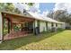 Exterior view of house with covered patio at 12805 Flint Creek Rd, Thonotosassa, FL 33592