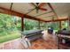 Covered patio with table, seating, and fire pit at 12805 Flint Creek Rd, Thonotosassa, FL 33592