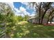 Landscaped yard with detached garage at 12805 Flint Creek Rd, Thonotosassa, FL 33592
