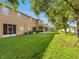 Green backyard featuring grass, trees, and privacy fence at 12820 Belvedere Song Way, Riverview, FL 33578