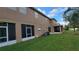 Two-story home featuring a spacious backyard with lush greenery and a screened lanai at 12820 Belvedere Song Way, Riverview, FL 33578